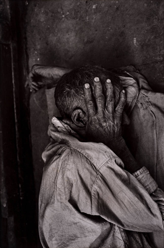 India (Man with hand over face)