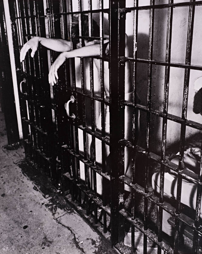 Newark Essay (Inmate’s arms hanging out of jail cell)