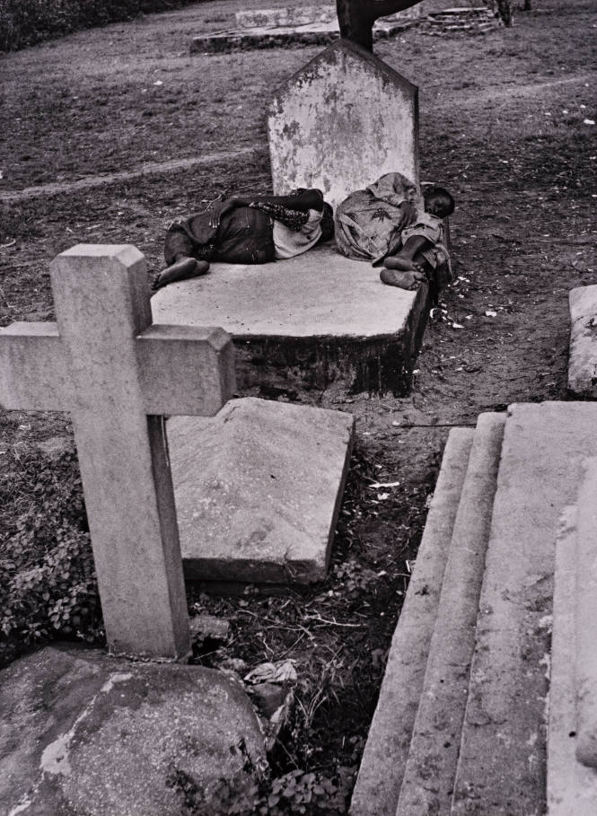 Lagos, Nigeria (Two people sleeping on gravestone)