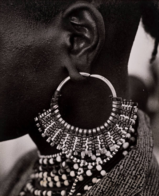 “Northern region, Near Kano, a Fuloni boy aged 17 lets me photograph a close up of his silver and bead earing,”