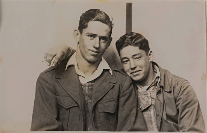 Two Young Men Embracing, Striped Background
