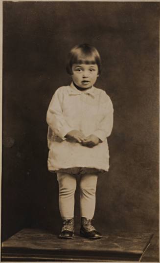 Infant Girl Standing on Table