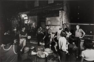The neighborhood gathered to watch. Somewhere within the building a man was concealed with a gun