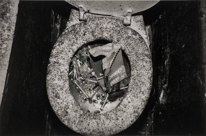 "Shooting gallery" lavatory clogged with gelatine capsules and syringes