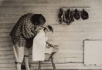 Mother Cutting Her Son's Hair