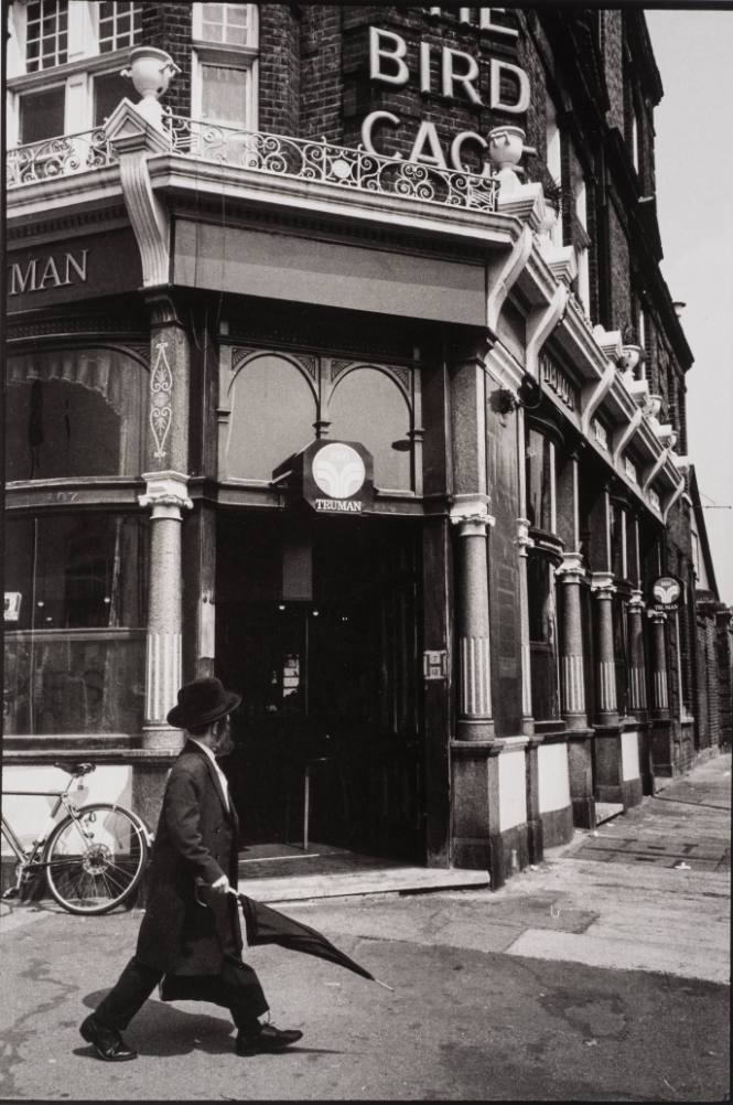 Boy Walking with Umbrella, London, England