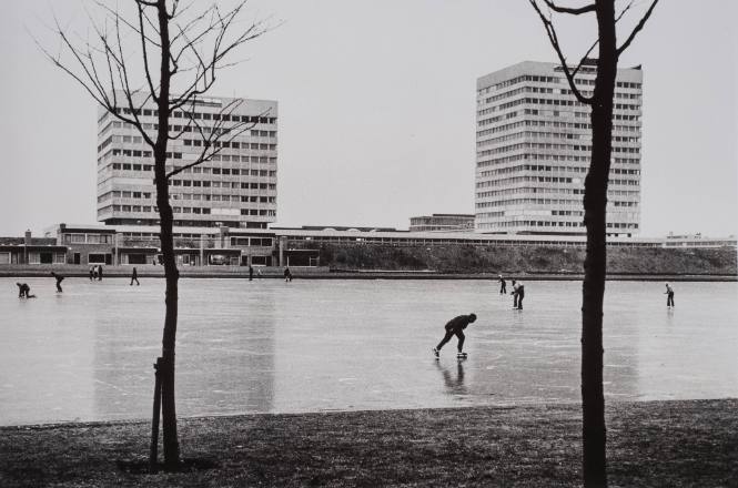 Skaters, Walkers on Frozen Canal with Modern Building in Background, Amsterdam, Holland