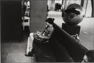 Untitled, from Women are Beautiful [Woman Writing on Bench Near Pomodoro Sculpture]