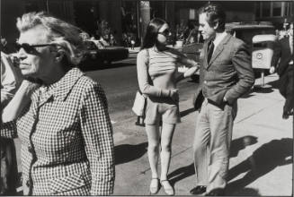 Untitled, from Women are Beautiful [Young Couple Passed by an Older Woman in Sun Glasses]