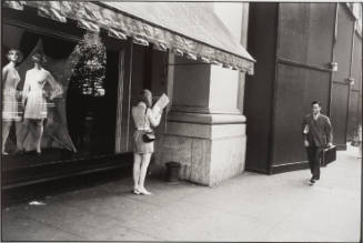 Untitled, from Women are Beautiful [Woman Reading Newspaper by Store Window]