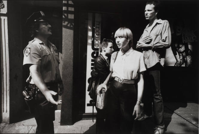 New York's "Ninth Precinct Police Station, is not all crime, some cops do public relations duties with local citizens, like these three punks hanging around the street corners"