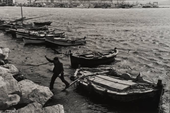 Fisherman jumping off the boat, Sicily, Italy