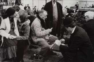 Two men playing cards while a young couple kissing beside, Paris, France
