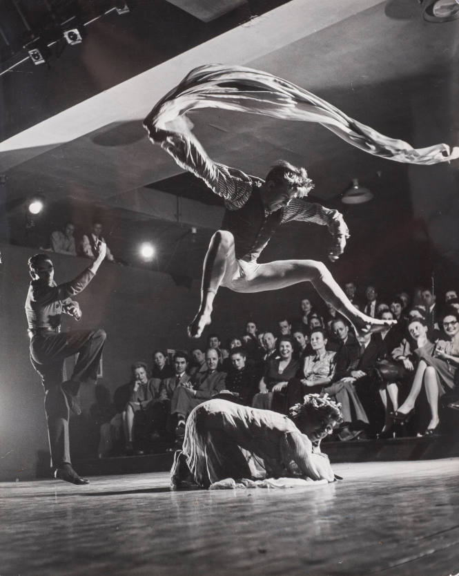 Dancer-choreographer Charles Weidman with dancer Peter Hamilton dancing as fire over a victim in the choreographer's modern interpretive dance called "And Daddy Was a Fire," on Broadway, NY