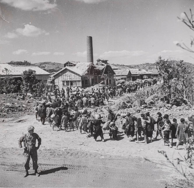 Okinawa - Hundreds of people with belongings moving into village that is to be their home, Japan