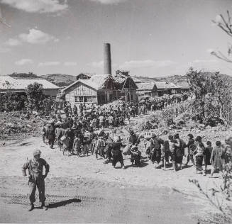 Okinawa - Hundreds of people with belongings moving into village that is to be their home, Japan