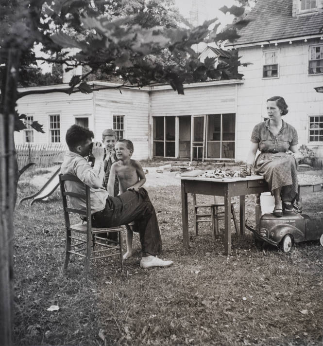 Mother and father playing in backyard with children
