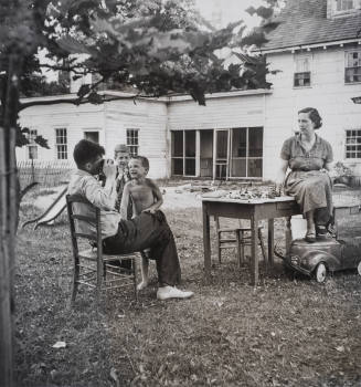 Mother and father playing in backyard with children