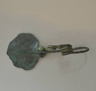 Fibula, elaborate type, with clasp of flattened bronze ornamented with incised patterns; quadruple spiral spring
