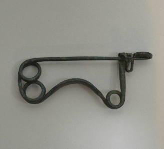 Spiral fibula, flattened bow decorated with four rows of incised dots
