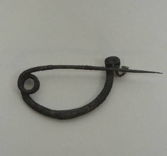 Bow-type fibula with double spiral at spring, double-hairpin-turn clasp and incised lines in the bow