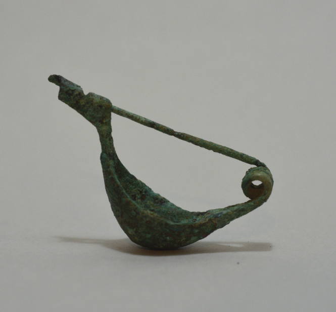Fibula "a navicella," ornamented with incised lines; double spiral spring