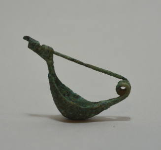 Fibula "a navicella," ornamented with incised lines; double spiral spring
