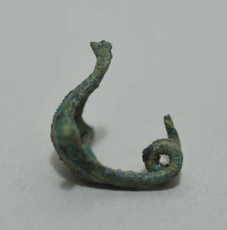 Fibula "a navicella," with triple spring and knobs at side of bow, with incised decoration and longitudinal ridge on bow.