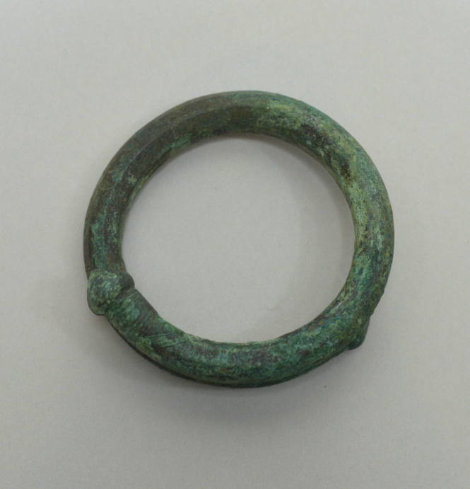 Spiral heavy bracelet with knobs and incised lines at each end