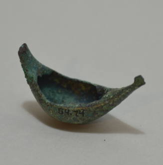 Fibula "a navicella," with impressed concentric circles and incised lines