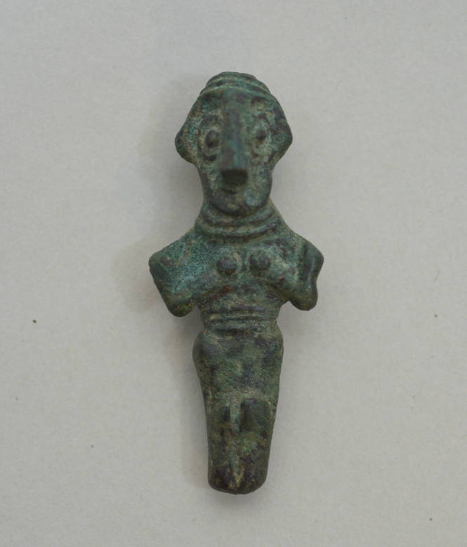 Western Asiatic figurine of a woman, holding her breasts; pendant loop; stylized features