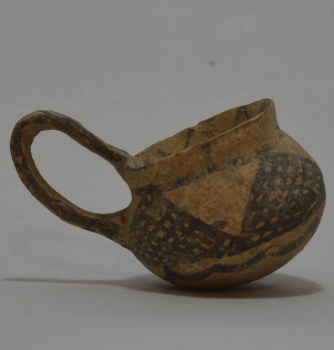 Small Cypriot buffware single-handled cup with painted cross-hatched triangles