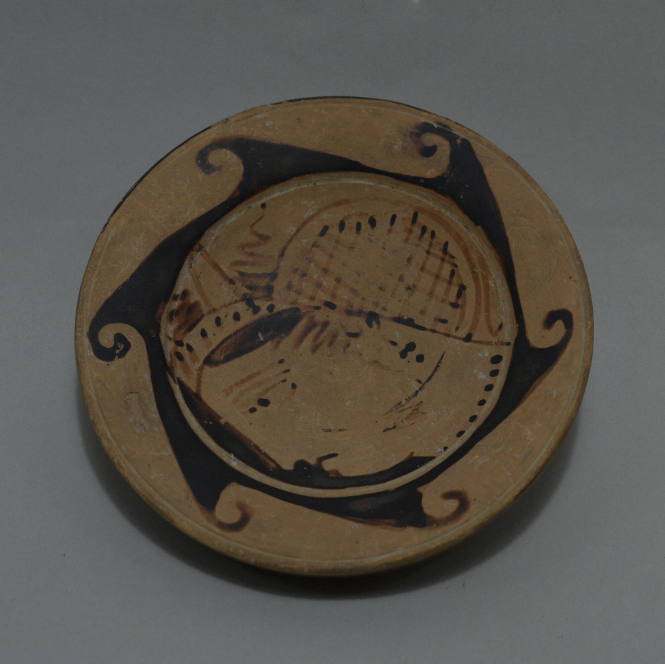 Faliscan high-footed plate, female head in profile with wave border