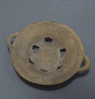 Cypriot bowl with lateral handles and triangular-shaped perforations