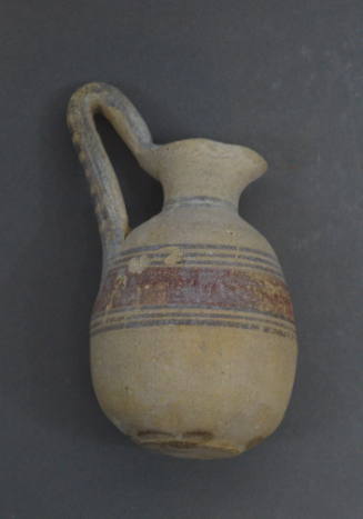 High-handled jug with brown and red banded decoration