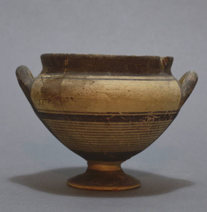 Cup, piriform on high foot, with lateral handles and painted decorative bands in brown and red