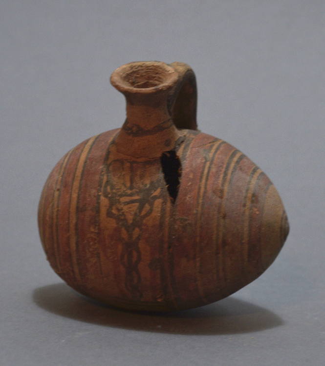 Cypriot barrel-jug with vertical circle decoration in brown and red and cross hatching below handle