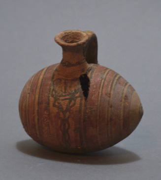 Cypriot barrel-jug with vertical circle decoration in brown and red and cross hatching below handle