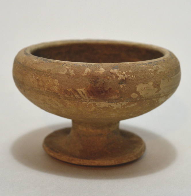 Footed up; buffware with dark glaze interior, 2 bands of decoration on exterior
