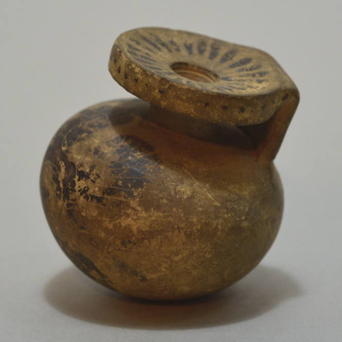 Italo-Corinthian round aryballos with snake-tailed, winged bearded figure