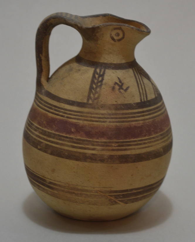 Trefoil-lipped Oinochoe, decorated with painted bands; and chevrons and swastikas on shoulder; eyes on spout