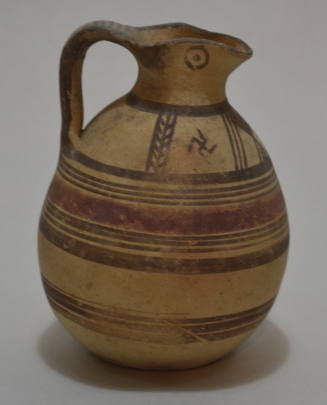 Trefoil-lipped Oinochoe, decorated with painted bands; and chevrons and swastikas on shoulder; eyes on spout