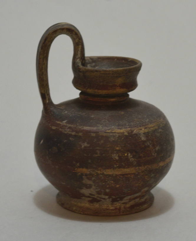 Small black-glazed jug with high handle