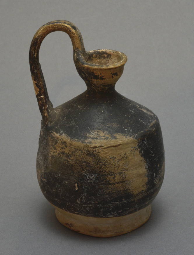 Black-glazed jug with high-swung handle