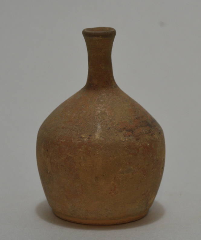Small buffware bottle with remains of black ornament on shoulder