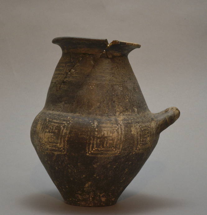 Villanovan cinerary urn, black impasto ware with incised decoration of lines, meanders, etc.