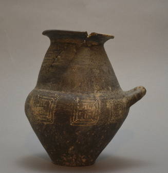 Villanovan cinerary urn, black impasto ware with incised decoration of lines, meanders, etc.