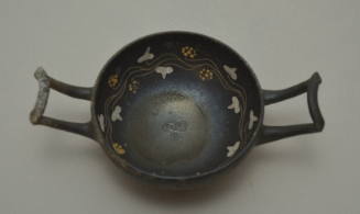 Apulian kylix with lateral wishbone handles; interior decorated with vine scroll and stamped palmette