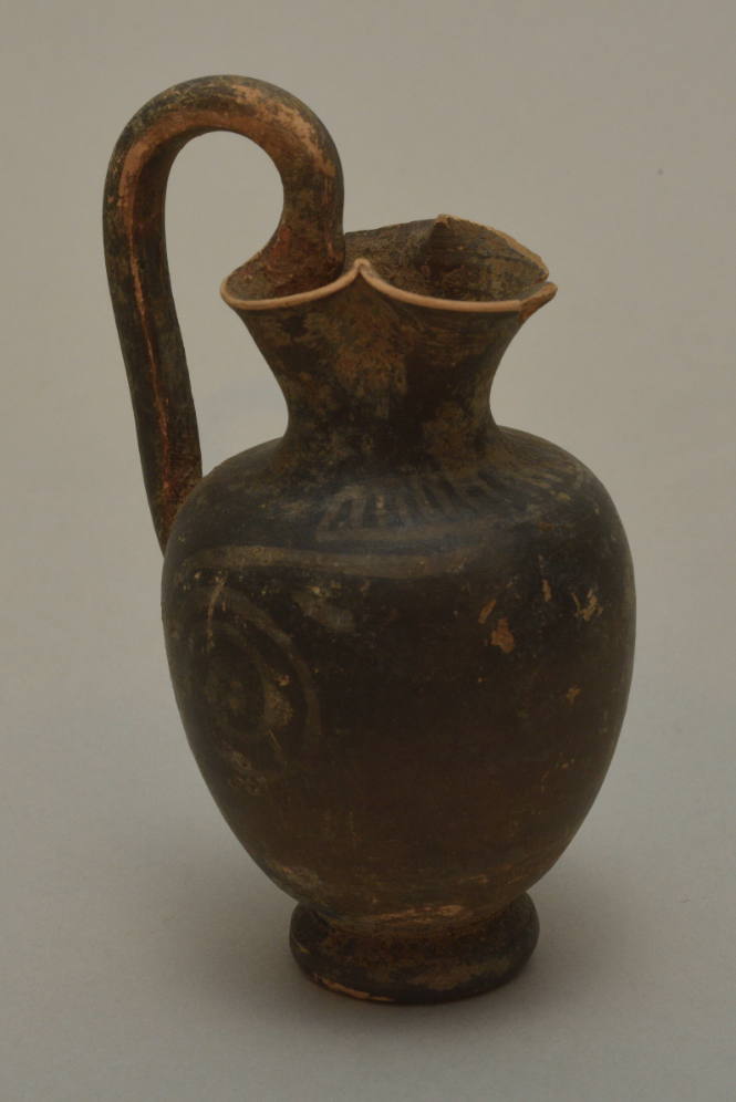 Gnathian trefoil oinochoe; standing figure and spiral decoration almost worn away, mouth damaged