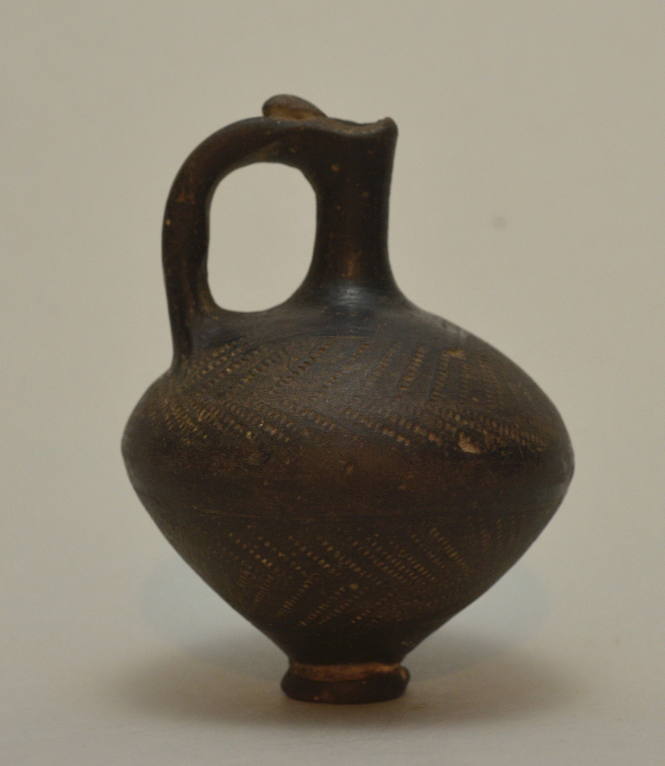 Jug of black ware ornamented with herringbone dotted pattern